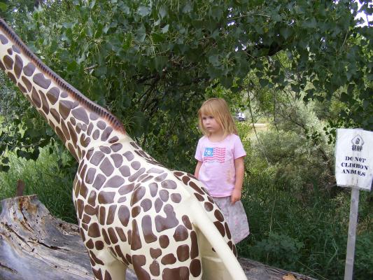 Sarah by a giraffe sculpture.