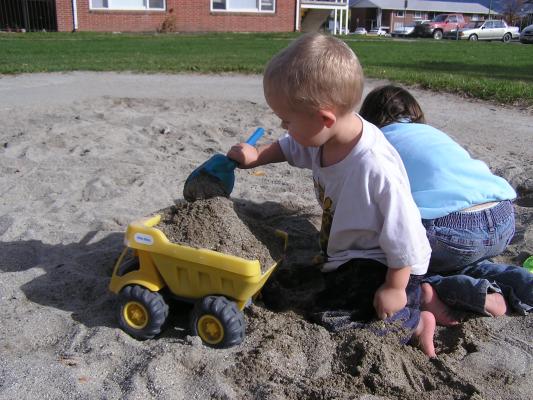 Noah and Andrea play in the sand.