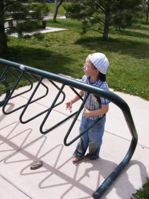 Noah plays with the bike rack at the picnic area at Bozeman Pond.