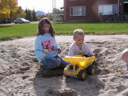 Andrea and Noah play in the sand.