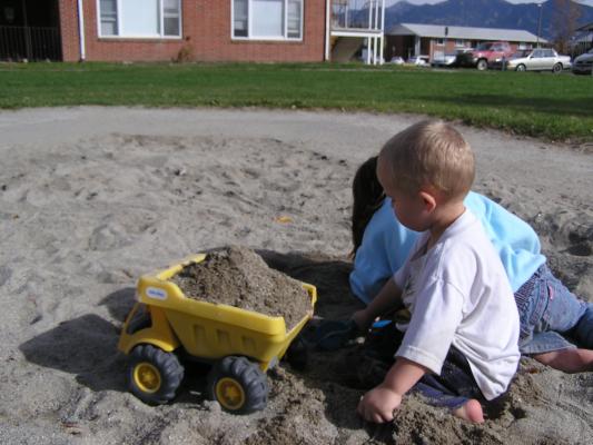 Noah and Andrea play in the sand.