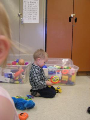 Noah plays with toys in the nursery.