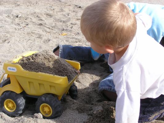 Noah fills a truck that was in the sandbox when we came to the playground.