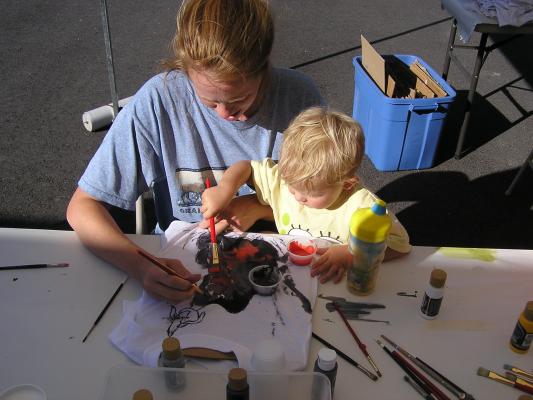 Katie and Noah paint a shirt for VBS.