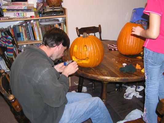 Myke continues multilating the pumpkin.