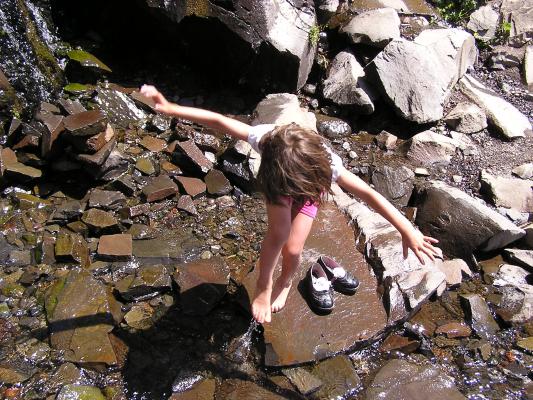 Andrea tries to fall into the stream.