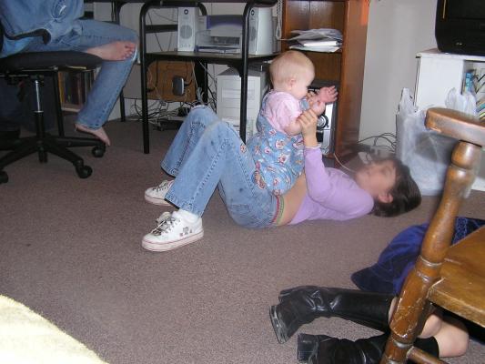 Sarah, Malia, and Andrea play on the floor.