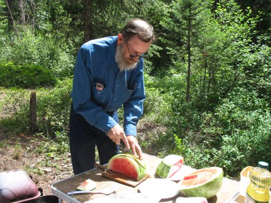 Robert carves the watermelon.