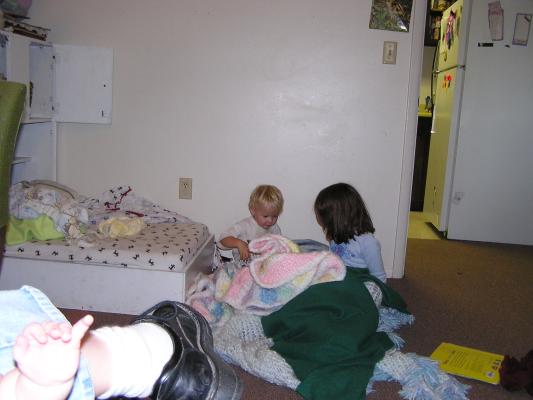 Noah and Andrea play make a bed.