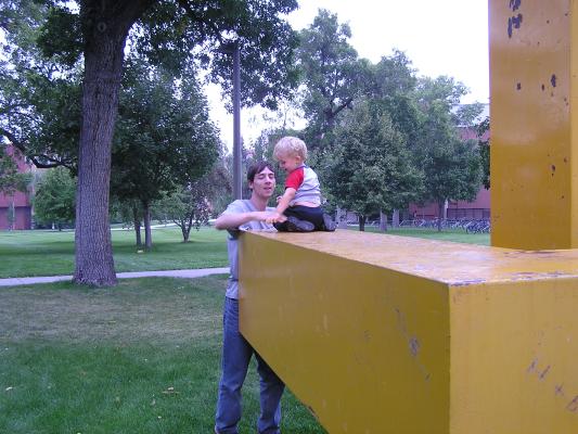 Noah plays on his favorite piece of art at the University.