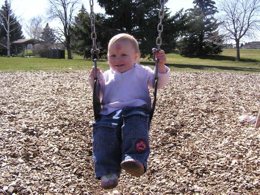 Sarah swings at the park.